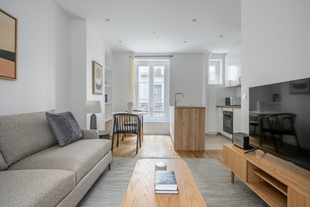 a living room filled with furniture and a flat screen tv